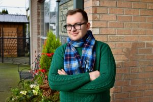 Newly hired receptionist Volodymyr Ivashyna poses for a photo outside the Chilliwack Hospice Society office building.